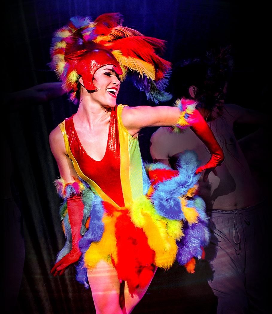 Actor/dancer in brightly colored, feathered costume